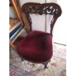 Victorian carved mahogany balloon back nursing chair on cabriole front supports