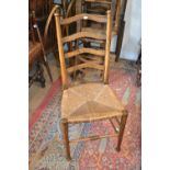 Set of four oak ladder back chairs with rush seats designed by William Birch of High Wycombe,