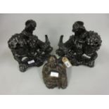 Pair of oriental carved hardwood groups of figures on stylised water buffalo, together with a carved
