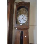19th Century French comtoise longcase clock, the grained pine case enclosing an embossed brass and