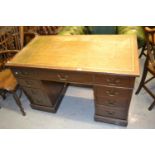 Late 19th or early 20th Century mahogany twin pedestal desk with a green leather inset top