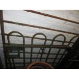 Early 20th Century green painted iron garden gate, 33ins wide, on gate posts, together with a