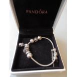 Pandora bracelet with eight charms in original box together with a quantity of silver and other