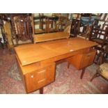 Mid 20th Century G-plan teak dressing table with a triple section mirror above a jewel drawers,