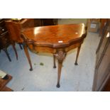 Mid 20th Century figured walnut card table, the shaped moulded top above carved cabriole supports,