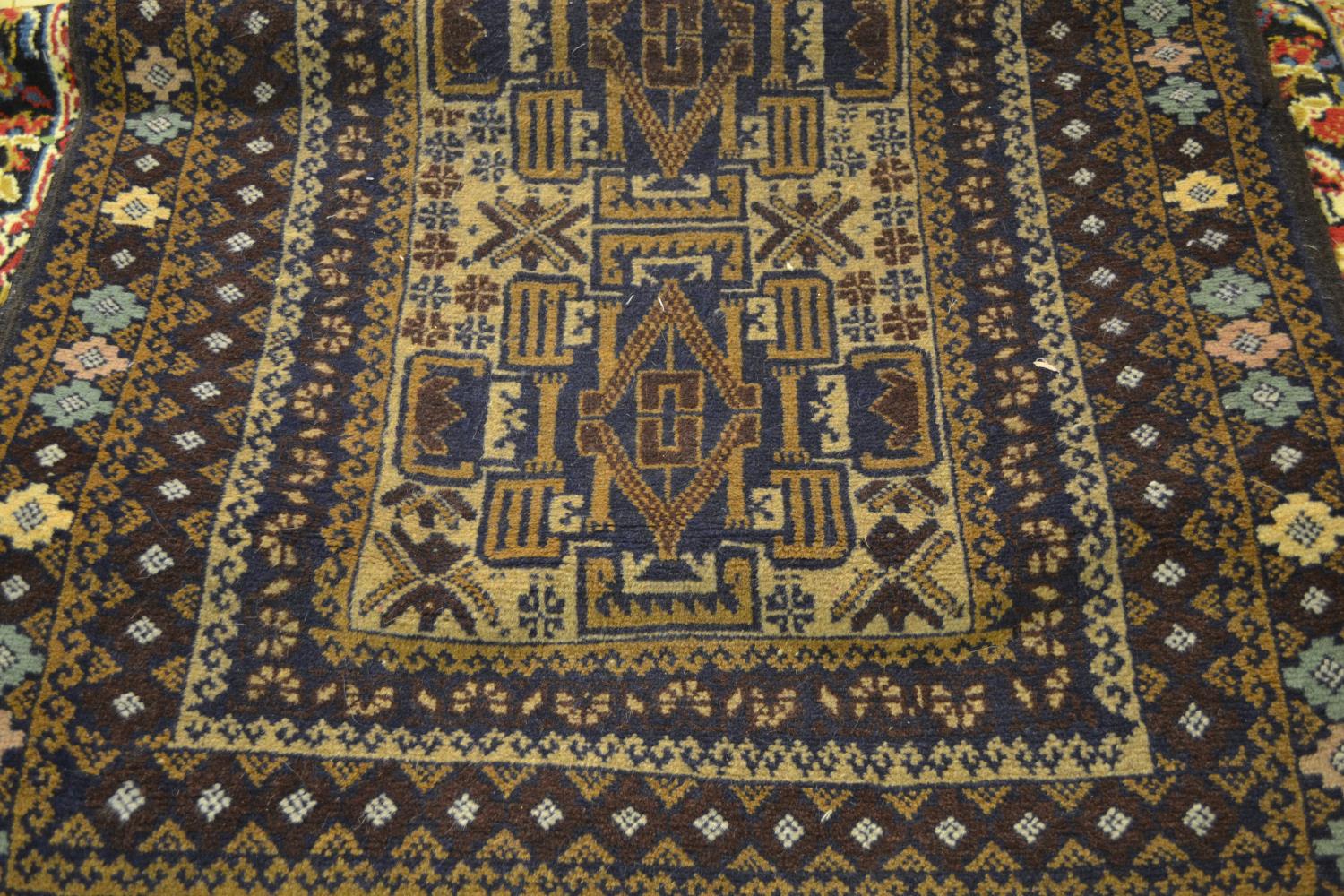 Small rug having single row of three medallions with multiple borders on beige and brown ground, 4ft