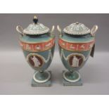 Pair of 19th Century Wedgwood two handled pottery vases with covers, relief moulded with signs of