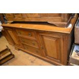 Early 20th Century oak sideboard with three central drawers flanked by rectangular panelled doors on