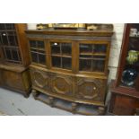 Mid 20th Century oak side cabinet having moulded galleried top with carved frieze above three bar