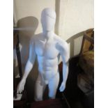 Modern male mannequin on a glass base
