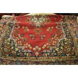20th Century machine made Persian style rug having all-over floral decoration with multiple