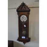 Late 19th Century miniature walnut Vienna wall clock, the enamel dial with Roman numerals and a