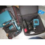 Makita pruning chainsaw, Model No. DUC121, in a Stanley tool bag and a Makita HP457D hand drill with
