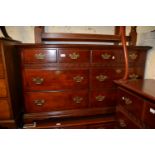 Pair of 20th Century faux wood chests of eight drawers on ogee bracket feet, 54ins wide x 18ins deep