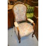 19th Century carved walnut open drawing room armchair on cabriole supports with brass casters