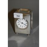 London silver cased carriage clock, the circular enamel dial having Roman numerals with a single