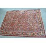 Large Mahal carpet with an all-over stylised floral design on a rose ground with borders (some