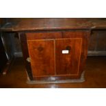 Antique oak spice cupboard, the single walnut veneered door enclosing eight drawers