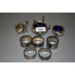 Three silver condiments and five silver napkin rings