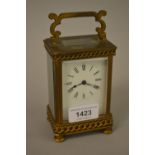 Early 20th Century gilt brass carriage clock with chain link design frieze, the enamel dial with