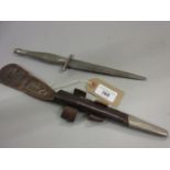 Mid 20th Century commando knife with steel blade and leather scabbard, marked 56 (at fault)