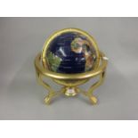 Reproduction globe inset with various minerals on a brass stand