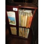 Mahogany table top revolving bookcase containing collection of Observer books