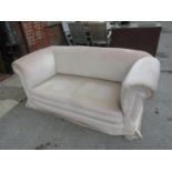 Late 19th or early 20th Century two seater Chesterfield type sofa with drop-end on four turned