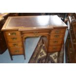 Small late 19th Century walnut inverted breakfront twin pedestal desk, the red tooled leather
