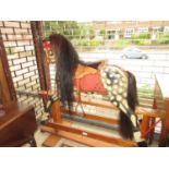 Early to mid 20th Century carved and painted dapple grey rocking horse on a polished stand with