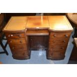 Victorian mahogany kneehole desk, the tooled leather inset top above an arrangement of nine