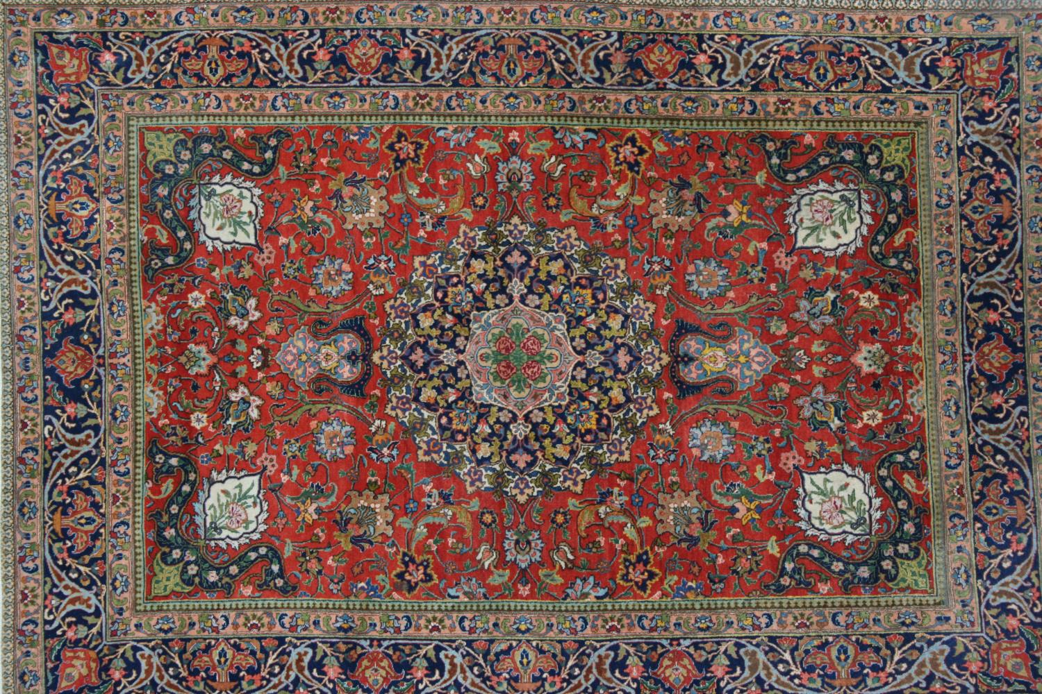 Pair of Tabriz rugs having central medallion with all-over floral design and multiple borders on a