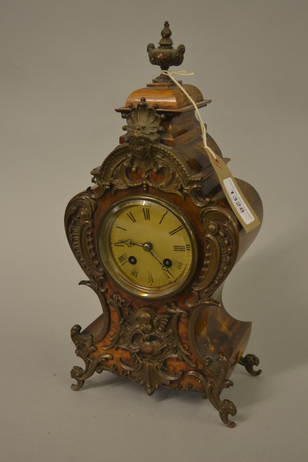 Small late 19th Century French beechwood and figured walnut two train mantel clock with patinated