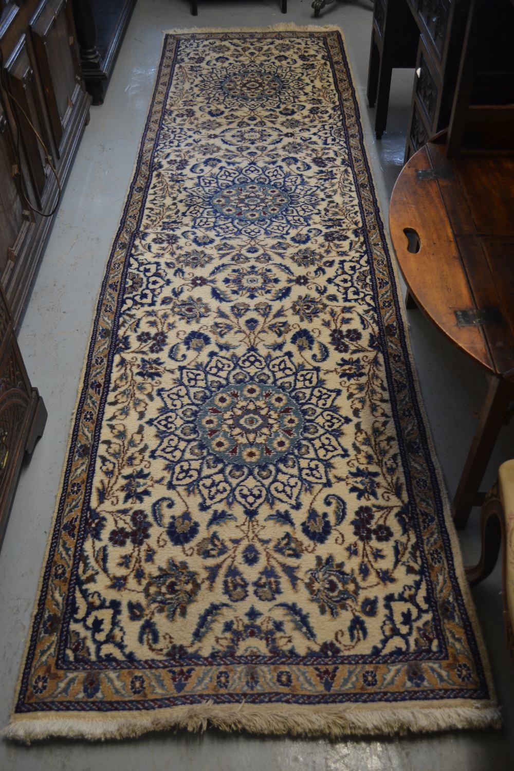 Nain design runner with a triple medallion design on an ivory ground with borders