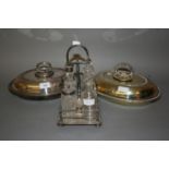 Two silver plated entree dishes and a silver plated four bottle condiment stand with associated
