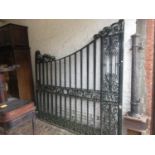 Pair of large green painted wrought iron gates with arched scroll surmounts, overall width 14ft 4ins