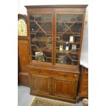 Early 20th Century mahogany bookcase, the moulded cornice above a pair of astragal glazed doors