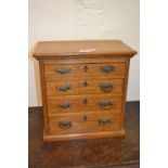 19th Century oak table top collector's chest of four drawers with brass handles on a moulded