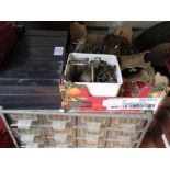 Two multi drawer table cabinets containing a quantity of clock related spares, parts, hinges, bolts,