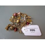 9ct Gold charm bracelet with multiple charms including a 22ct gold half sovereign 97g