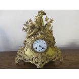 19th Century gilt cased mantel clock surmounted with a figure fishing with circular enamel dial