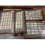 Four framed sets of Players cigarette cards, including World War II aeroplanes and Squadron emblems