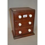 19th Century miniature three drawer table top chest with white ceramic handles