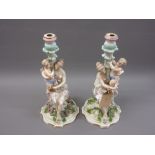 Pair of 19th Century French porcelain figural candlesticks (some damages), 14ins high