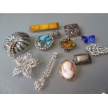 Bag containing a quantity of various decorative brooches including two silver