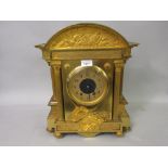 19th Century French gilt brass mantel clock of architectural form, the broken arch top inset with