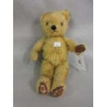 Small early 20th Century straw filled jointed teddy bear
