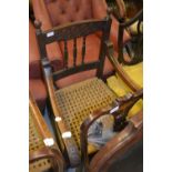 Pair of 19th Century French oak open elbow chairs with rush seats (at fault)