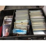 Black suitcase containing a collection of various Continental and English postcards including