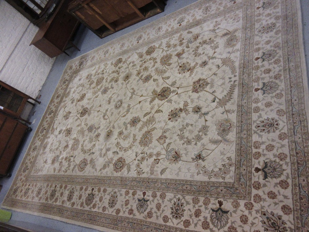 Indo Persian style carpet of all-over floral design with multiple borders on a beige ground, 9ft